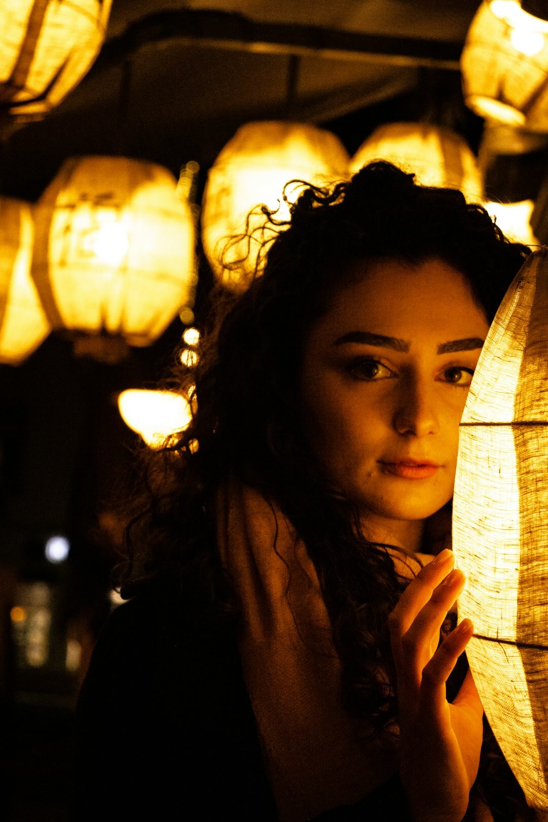 Portrait of a German woman in her late twenties with curly dark hair