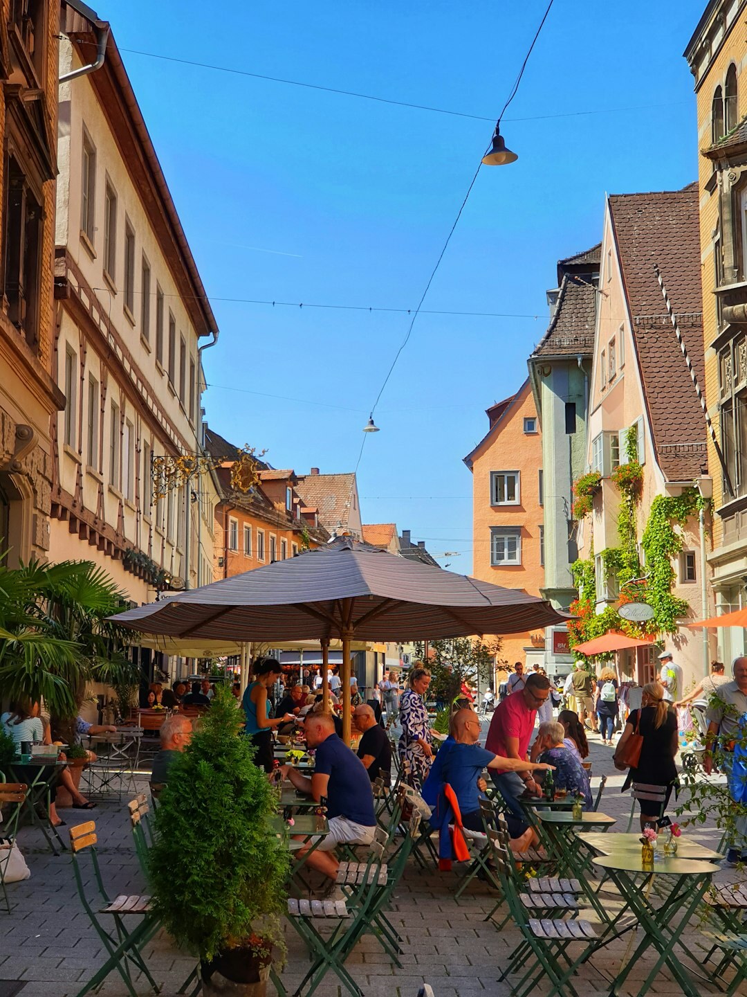 Cafe terrace in a German city street with people relaxing